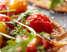 Flatbreads with Caramelized Onions, Tomatoes, Boursin and Arugul